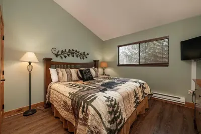a bedroom with a bed and a television in it at Beaver Village Unit #0333 in Winter Park