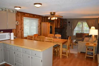a kitchen and living room with a table and chairs at Beaver Village Unit #0521R in Winter Park