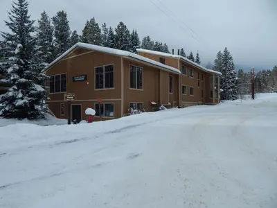 a building on a snow covered road in front at Beaver Village Unit #0521R in Winter Park
