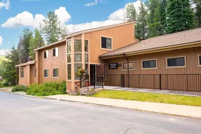 a brown building with a gate and a street at Beaver Village Unit #0521 in Winter Park