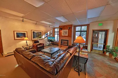 a large living room with a leather couch at Beaver Village Unit #0521 in Winter Park