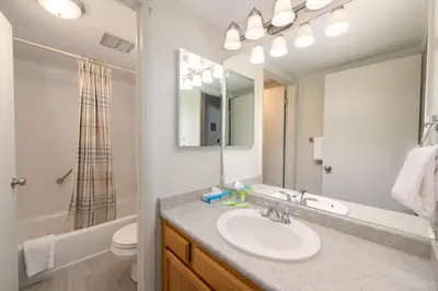a bathroom with a sink and a toilet and a mirror at Meadow Ridge Court 9 Unit 4 in Fraser