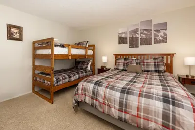 a bedroom with a bunk bed and a chair at Meadow Ridge Court 9 Unit 4 in Fraser