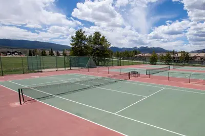 a tennis court with two tennis nets on it at Meadow Ridge Court 9 Unit 4 in Fraser