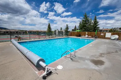 a large swimming pool with a blue at Meadow Ridge Court 9 Unit 4 in Fraser