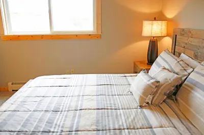 a bedroom with a bed and a window at Meadow Ridge Court 8 Unit 6 in Fraser