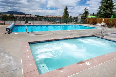 a large swimming pool with blue water at Meadow Ridge Court 8 Unit 6 in Fraser