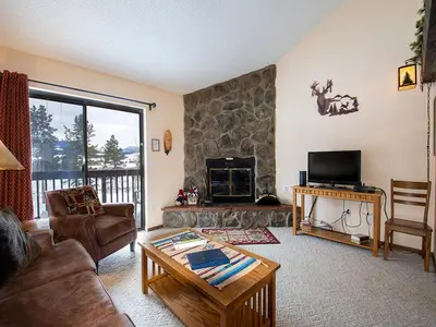 a living room with a couch and a fireplace at Meadow Ridge Court 28 Unit 6 in Fraser