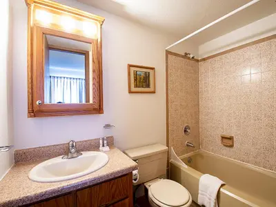 a bathroom with a sink and a toilet and a tub at Meadow Ridge Court 28 Unit 6 in Fraser