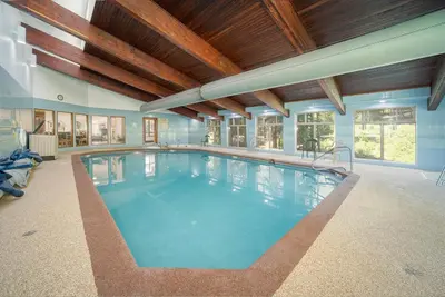 a large indoor swimming pool with a wooden ceiling at Beaver Village Unit #0232R in Winter Park