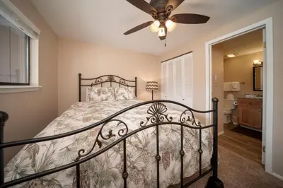 a bedroom with a bed and a ceiling fan at Beaver Village Unit #0412 in Winter Park