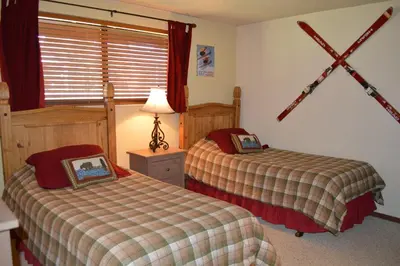 a bedroom with two beds and a window at Beaver Village Unit #0612 in Winter Park