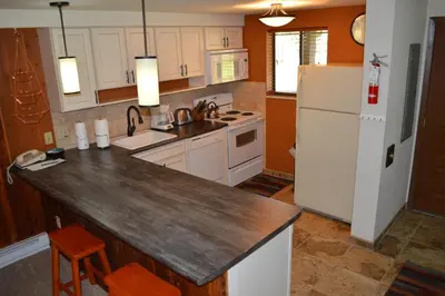 a kitchen with white appliances and a white refrigerator at Beaver Village Unit #0612 in Winter Park