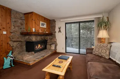 a living room with a couch and a fireplace at Beaver Village Unit #0621 in Winter Park