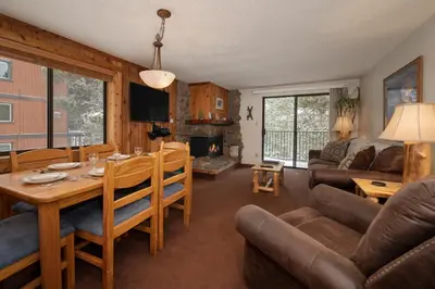 a dining room and living room with a table and chairs at Beaver Village Unit #0621 in Winter Park