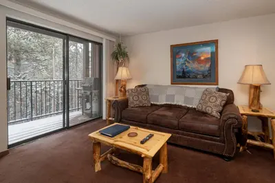 a living room with a couch and a table at Beaver Village Unit #0621 in Winter Park