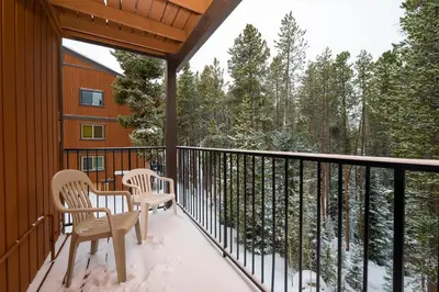 a balcony with two chairs and a table on it at Beaver Village Unit #0621 in Winter Park