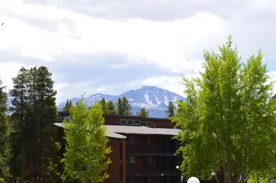 a building with a snow covered mountain in the background at Beaver Village Unit #0623R in Winter Park