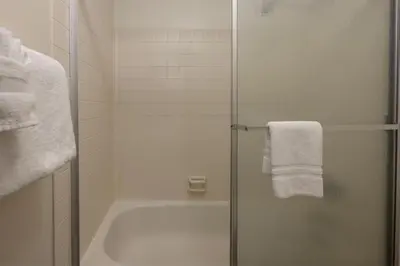 a bathroom with a shower with a tub and a towel at Beaver Village Unit #0623R in Winter Park