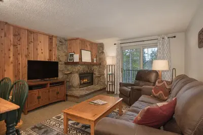 a living room with a couch and a fireplace at Beaver Village Unit #0623R in Winter Park
