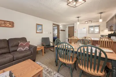 a living room with a table and chairs and a couch at Beaver Village Unit #0623R in Winter Park