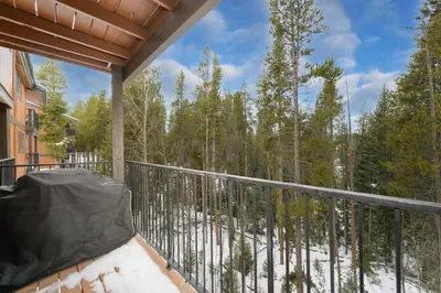 a balcony with a view of the woods at Beaver Village Unit #0623 in Winter Park