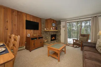 a living room with a couch and a fireplace at Beaver Village Unit #0711R in Winter Park