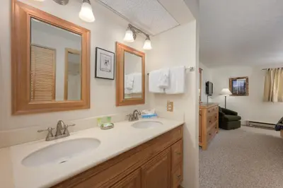 a bathroom with two sinks and a mirror at Beaver Village Unit #0711 in Winter Park