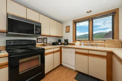 a kitchen with a stove and a microwave at Crestview Place Unit 607 in Winter Park