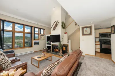 a living room with a couch and a fireplace at Crestview Place Unit 607 in Winter Park