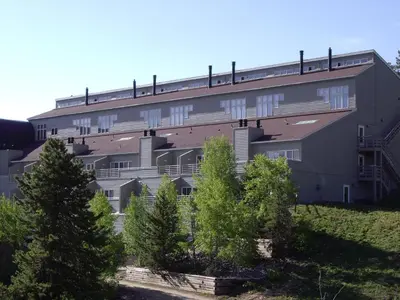 a large building with trees in front of it at Crestview Place Unit 607 in Winter Park