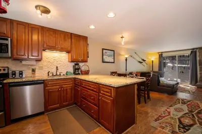 a kitchen with wooden cabinets and a kitchen island at Beaver Village Unit #0211 in Winter Park