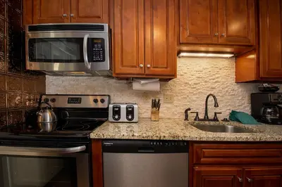 a kitchen with a stove microwave and a sink at Beaver Village Unit #0211 in Winter Park