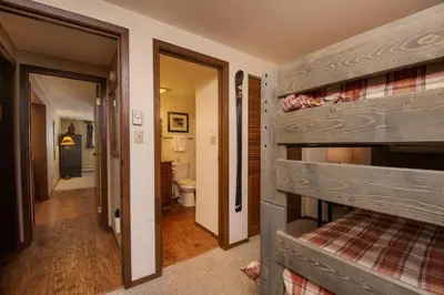 a room with a bunk bed and a bathroom at Beaver Village Unit #0211 in Winter Park
