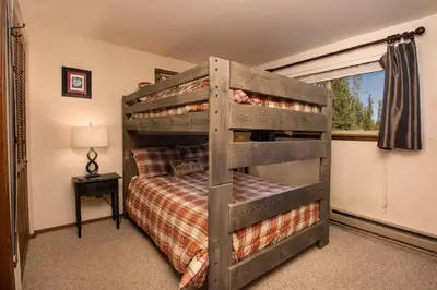 a bedroom with a bunk bed and a window at Beaver Village Unit #0211 in Winter Park