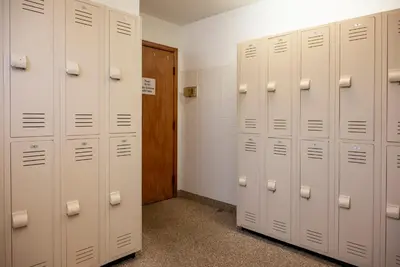 a row of white lockers in a locker room at Beaver Village Unit #0211 in Winter Park