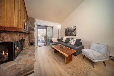 a living room with a couch and a fireplace at Beaver Village Unit #0332 in Winter Park