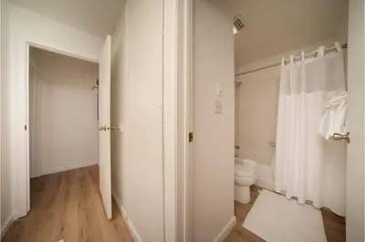 a white bathroom with a toilet and a shower at Beaver Village Unit #0332 in Winter Park