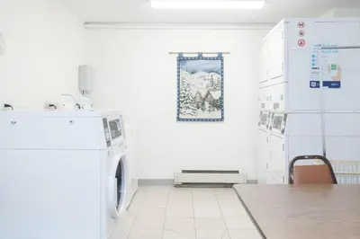 a white laundry room with a washer and dryer at Beaver Village Unit #0332 in Winter Park