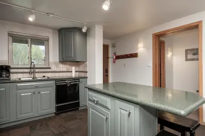 a kitchen with gray cabinets and a counter top at Beaver Village Unit #0514 in Winter Park