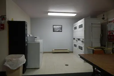a kitchen with white appliances and a table in a room at Beaver Village Unit #0514 in Winter Park