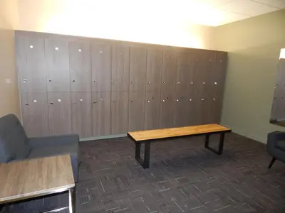 a locker room with a wooden table and a bench at Hi Country Haus Unit 1801 in Winter Park