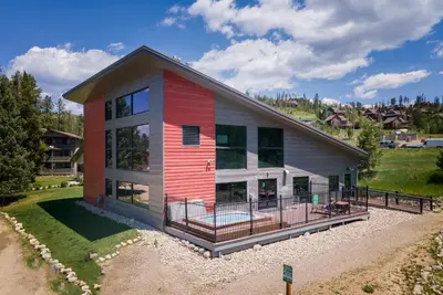 a home with a red and white house at Hi Country Haus Unit 1801 in Winter Park