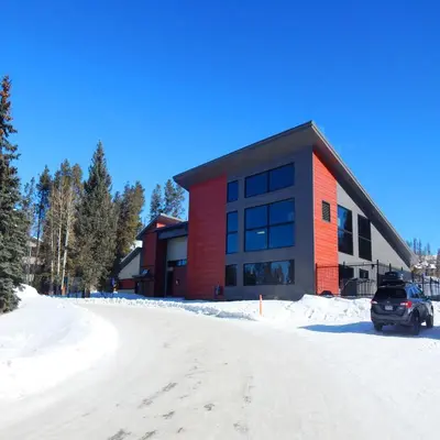 a red building with a car parked in front of it at Hi Country Haus Unit 1801 in Winter Park