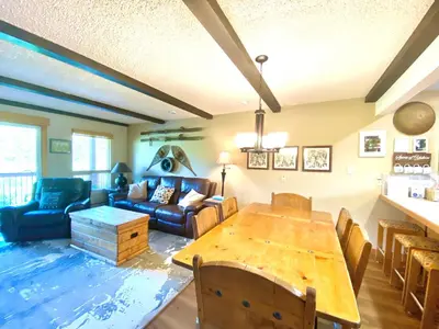 a living room with a table and a couch at Hi Country Haus Unit 1805 in Winter Park