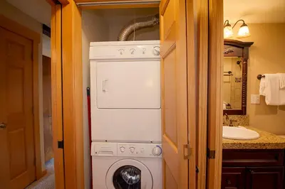 a washer and dryer in a small bathroom at Hi Country Haus Unit 1805 in Winter Park