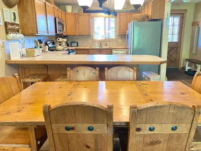 a kitchen with a large wooden table and chairs at Hi Country Haus Unit 1805 in Winter Park