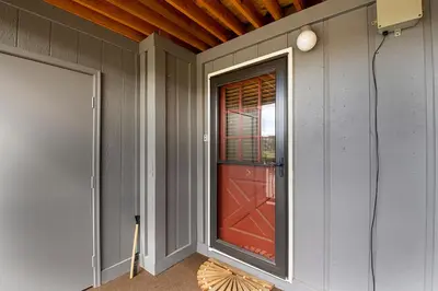 a red door on the side of a house at Hi Country Haus Unit 1805 in Winter Park