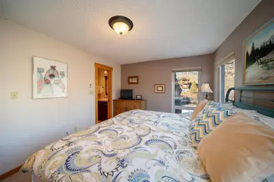 a bedroom with a bed with a blue and white comforter at Hi Country Haus Unit 1805 in Winter Park