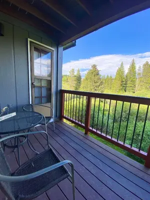 a balcony with a table and chairs on a deck at Hi Country Haus Unit 1805 in Winter Park